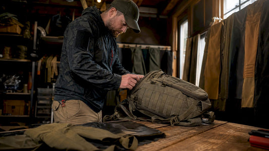 Specialist examining tactical gear under sunlight