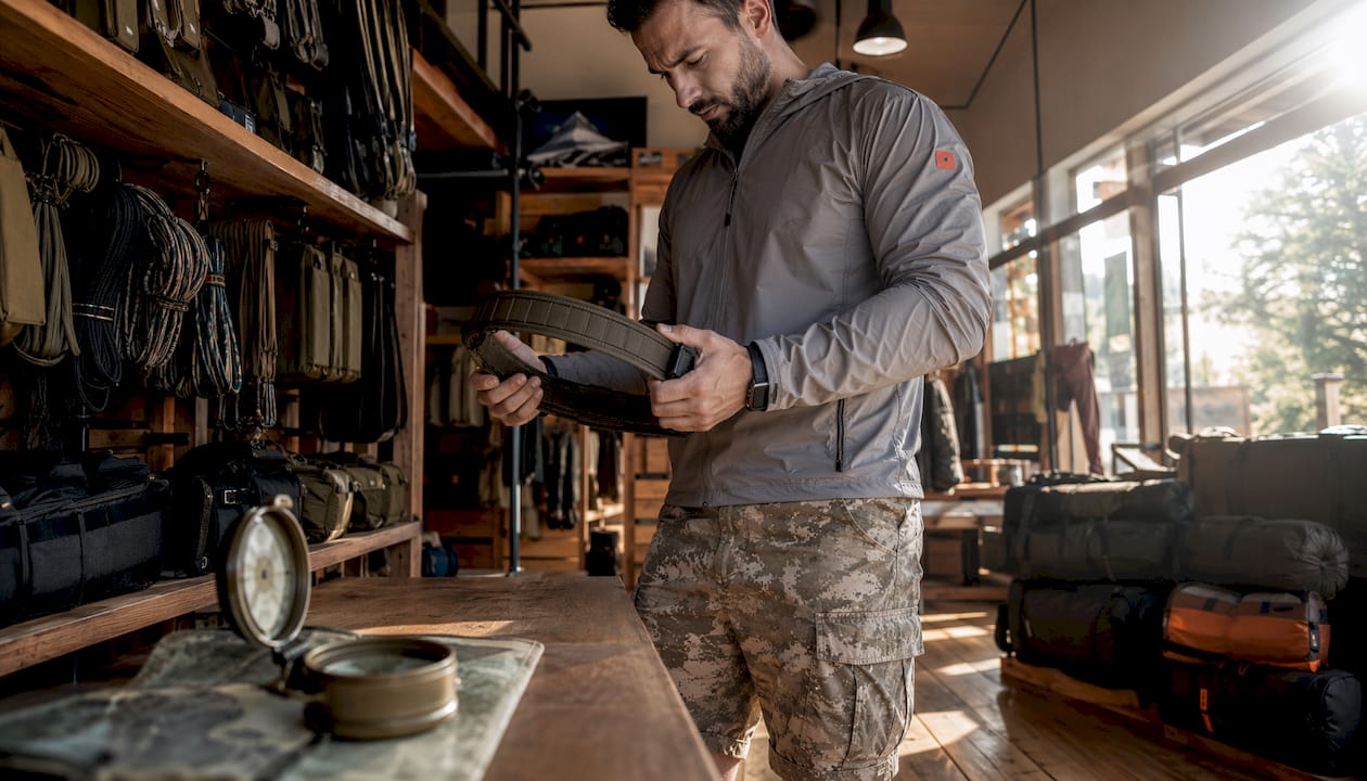 Man inspecting tactical belt in store