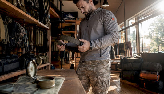 Man inspecting tactical belt in store